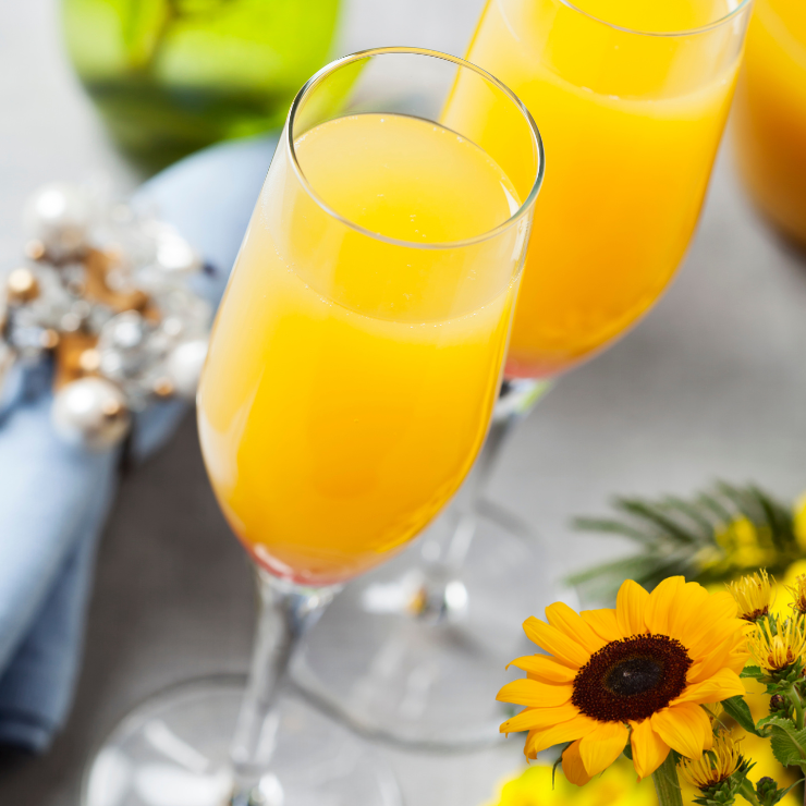 Bride to bee sunflower bridal shower drink in tall stemmed glass with sunflower table decor.