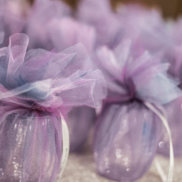 Dusty mauve wedding favors tied with silky ribbon.