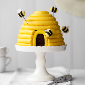 Bride to bee bridal shower bee hive cake with honey bee decorations.