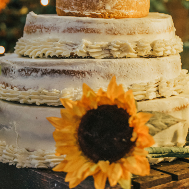 Bride to bee sunflower bridal shower tiered cake with white cream and sunflower decoration.