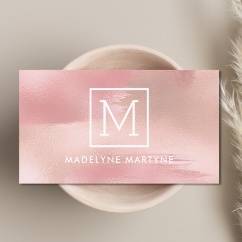 Chic classy business card with soft pink blush shimmer design and modern white logo monogram and sans serif typography text.