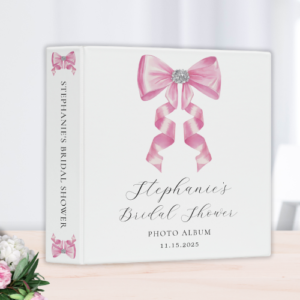 Shes tying the knot bridal shower coquette themed bridal shower photo album binder featuring a chic glam silky pink bow with sparkling rhinestones design and customizable modern script typography.