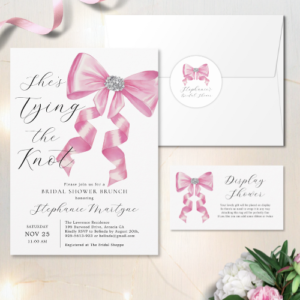 Shes tying the knot bridal shower coquette themed bridal brunch invitation with envelope and sticker and a display shower card featuring a chic glam silky pink bow with sparkling rhinestones design and customizable modern script typography.